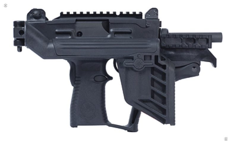 The right side of an Uzi PRO submachine gun with the stock folded forward to minimize the size of the weapon. The trigger can still be operated with the right hand as there is room underneath the folded stock for the fingers to fit, even if wearing a glove. With the stock folded in this manner, the buttplate can be used as a forward handgrip. This specimen has no magazine inserted. PHOTO CREDIT: IWI