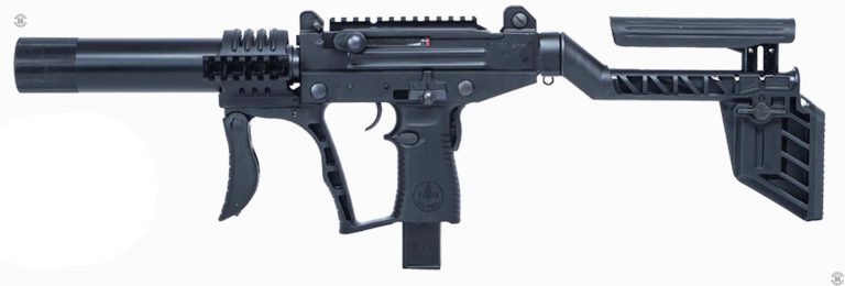 The left side of a suppressed Uzi PRO submachinegun with the stock extended and the cheekpiece raised. The front vertical assault grip is locked in the forward position for use. A circular guard surrounds the rear of the suppressor to help protect the operator’s hand from the heat of firing. The knurled top surface of the magazine catch can be seen just below and behind the trigger. The safety/selector switch above the pistol grip is in the rearmost, Safe. Position. PHOTO CREDIT: IWI