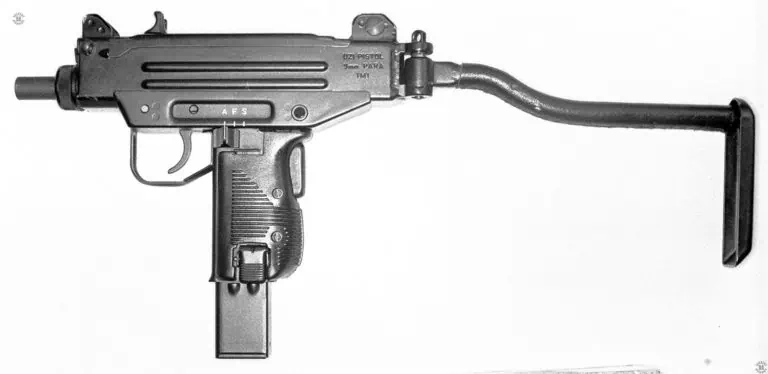 A left side view of a very early Micro-Uzi with the stock extended and locked. The center pistol grip is the same as the standard model as used in the Uzi pistol. The black plastic grips on the weapon are the rounded edge types used on the standard submachine gun. The controls are the same as for the standard Uzi models with the safety/selector switch pushed forward to the A or automatic fire position. Just in front of the hinge for the left-side folding stock are the markings for the Uzi pistol. The serial number would be underneath the IMI marking but has been blotted out on this illustration. PHOTO CREDIT: KEVIN DOCKERY