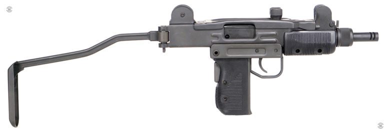 The right side of an unloaded Mini-Uzi with the stock extended. The stock is locked in place by the mechanism at the rear of the receiver. The spring-loaded stock lock has a small upper lug in the mechanism that pops up into the corresponding notch on the inside top of the lock. A hard strike on the left side at the rear of the stock forces the lug out of the stock lock and allows the stock to swing to the right side of the receiver and lock in place in the folded position. The bolt is in the forward, uncocked, position on this specimen. PHOTO CREDIT: IMI