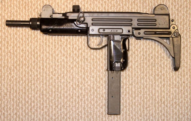 The left side of an Uzi, Number 2, Version 1 with the standard metal folding stock in the folded position. This specimen is loaded with the less common 40-round magazine. The selector switch is set on the central position for semiautomatic fire. PHOTO CREDIT: KEVIN DOCKERY