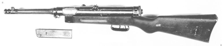 The Beretta Model 38/42 was developed as a simplified version of the Beretta 38A series. The barrel jacket has been eliminated entirely. To increase surface area for cooling longitudinal cuts extend from the breech of the barrel to end just behind the front sight. The compensator has been cut directly into the barrel, just in front of the front sight. The compensator consists of two deep cuts across the muzzle of the weapon. Many of the parts are made of sheet steel stampings and connected by welding. The design still uses the dual trigger system but there is no blocking switch for the rear full automatic trigger. The safety lever is on the side of the receiver, just above the rear of the finger groove in the stock. Underneath the weapon is a 20-round magazine. PHOTO CREDIT: US Army