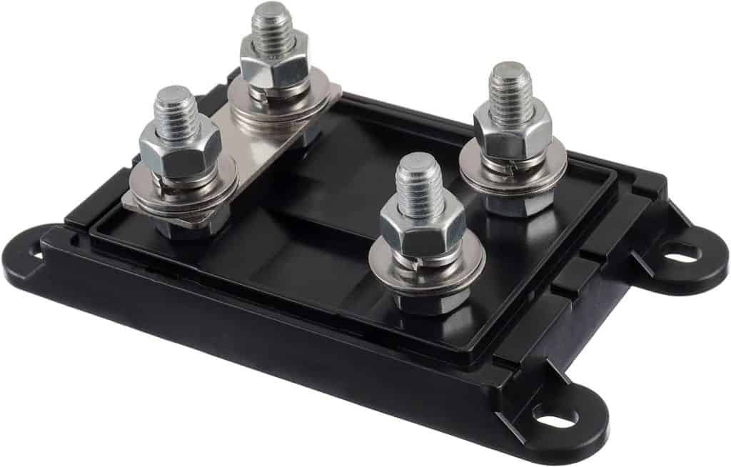 The ANL / CNL Fuse Holder is a black component featuring four metal bolts and nuts on top for electrical or mechanical connections. It has a rectangular base with mounting holes in each corner.