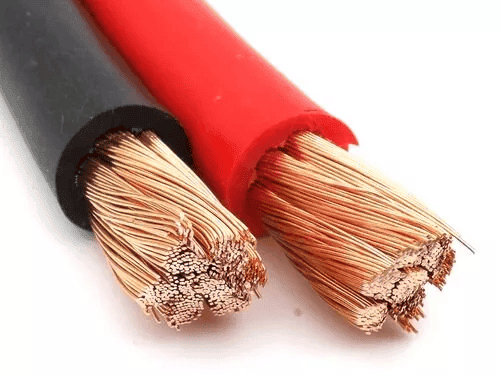 Red and black electrical cables, exposed copper strands.