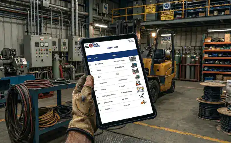 Maintenance technician using eWorkOrders mobile EAM app on tablet to access asset history, complete inspections, and log work at equipment location