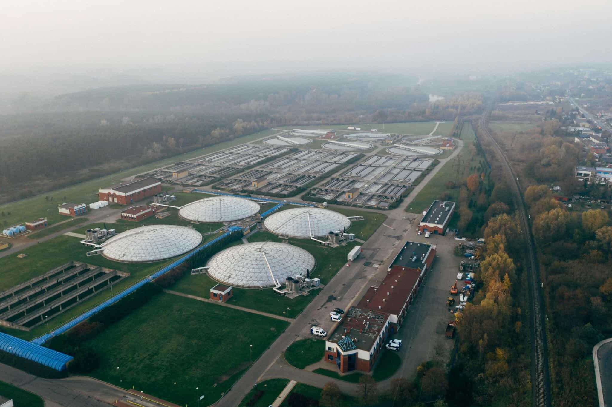 Aerial view of a wastewater treatment plant supported by enterprise asset management software for infrastructure visibility and maintenance planning