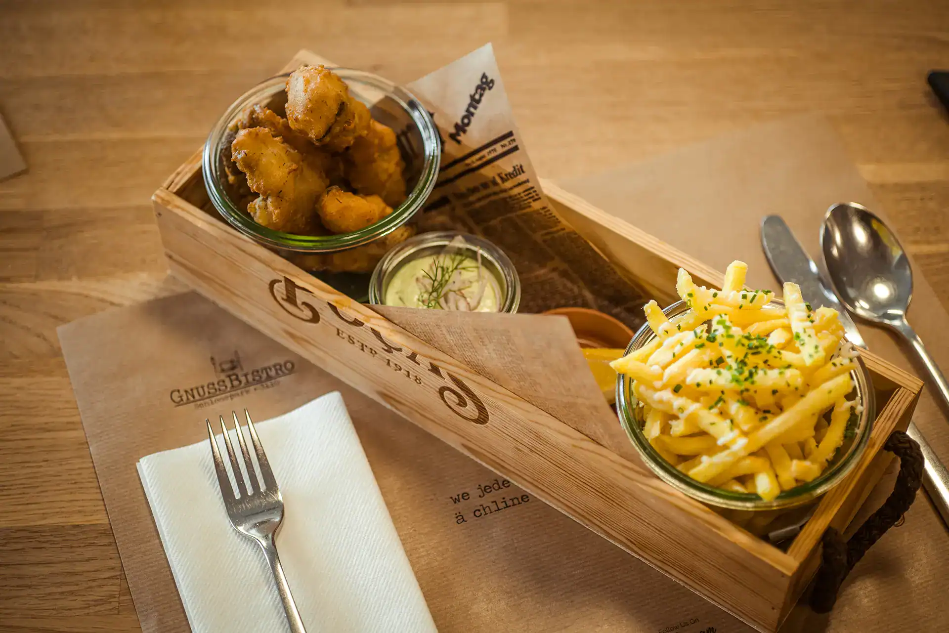 Knusprige Fischknusperli mit Sauce im Glas serviert