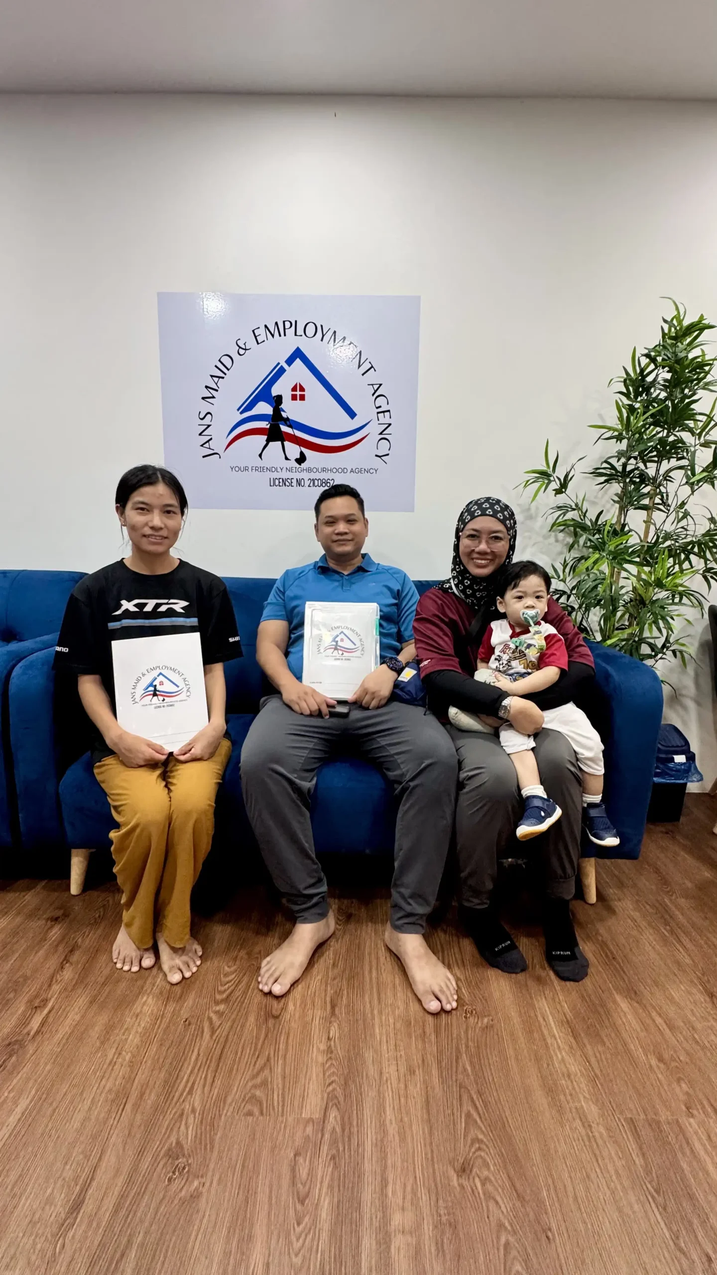 Happy family with their domestic helper in a Singapore living room