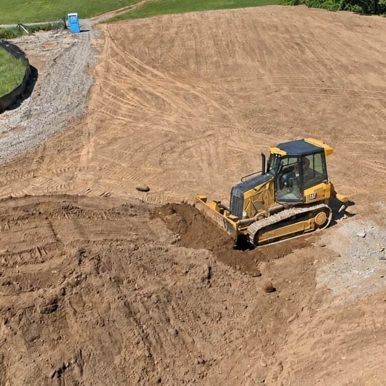 Dozer grading a building site on a sloped lot in Chapman, Oregon