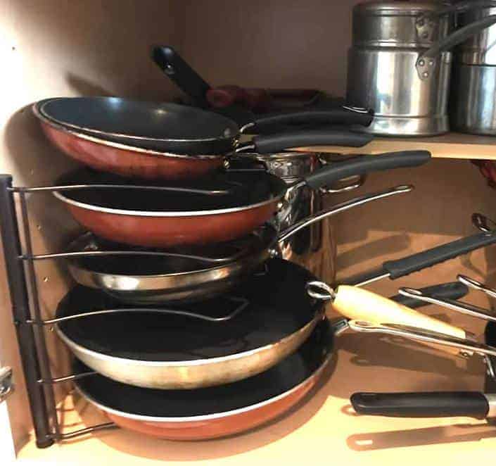 pans stacked in a kitchen cabinet