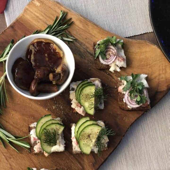 A tray of Polish appetizers on a wooden board.