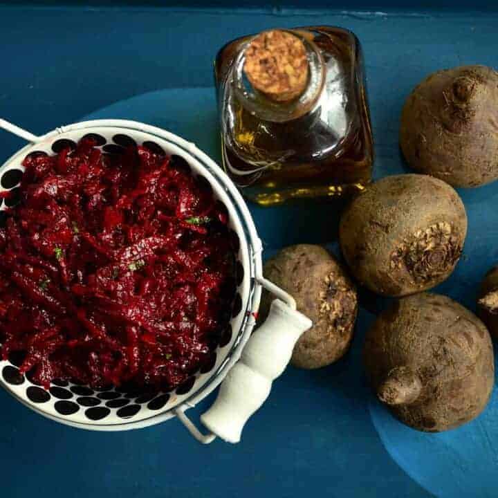 Buraczki in a bowl surrounded by beetroots.