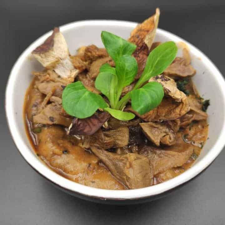 A homemade goulash featuring tender meat and a medley of vegetables, including flavorful mushrooms.