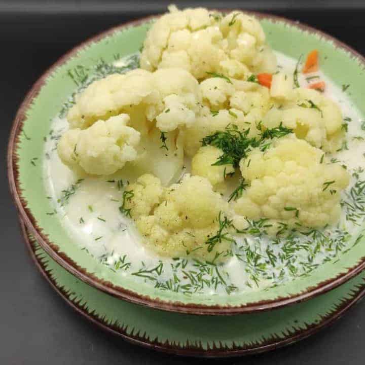 Polish cauliflower soup in a green bowl.