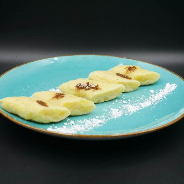 A plate with a few pieces of food on it, featuring a delicious Polish lazy pierogi recipe.