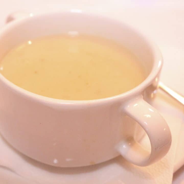 Soup Zalewajka in a white cup.