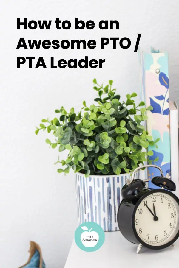 plant, binder and alarm clock on table