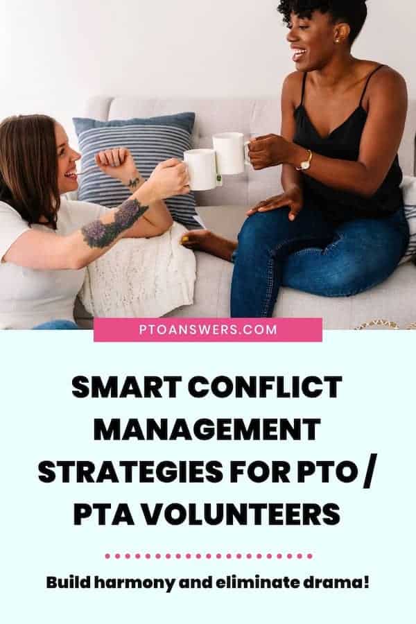 two women clinking coffee mugs in agreement in a living room