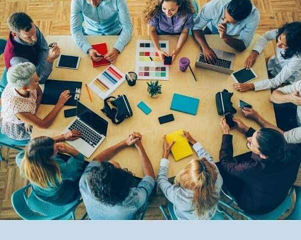 group os men and women working at conference table with title of blog post below
