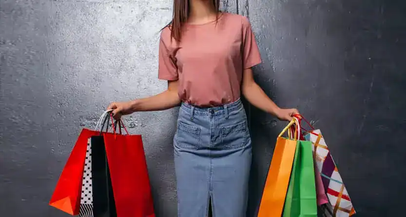 Stay at home mum starting a small t-shirt business from home with laptop and designs