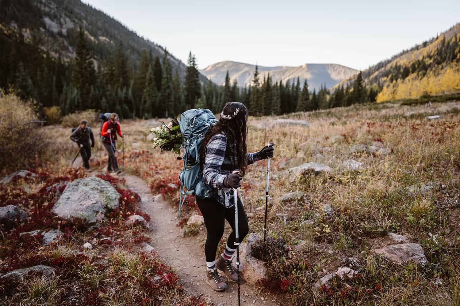 A bride hiking up a mountain in the fall in Colorado.