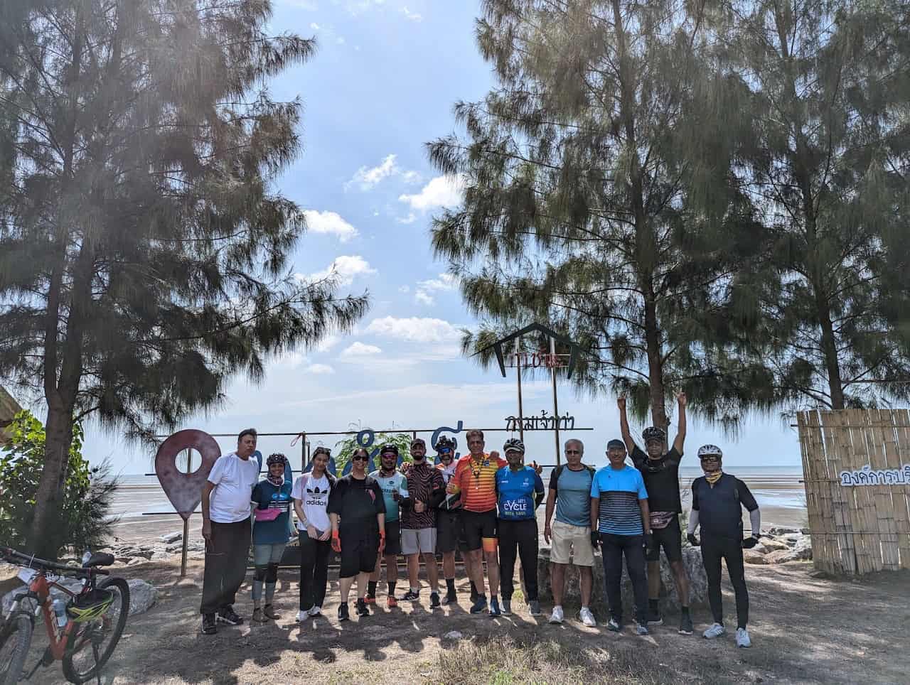 Cyclists riding on a Bangkok to Krabi bike tour through rural Thailand, passing quiet backroads, rice fields, traditional villages, limestone hills, and coastal scenery between Bangkok and Krabi.