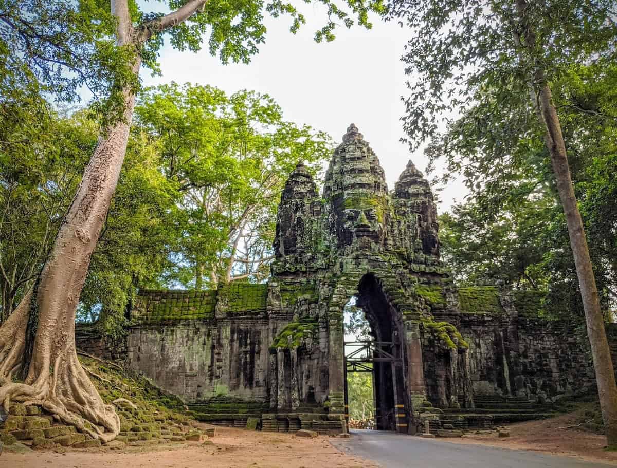 Cyclists exploring the countryside near Angkor Wat before continuing a cycling journey from Cambodia to Laos, riding through rural villages, rice fields, and scenic backroads.
