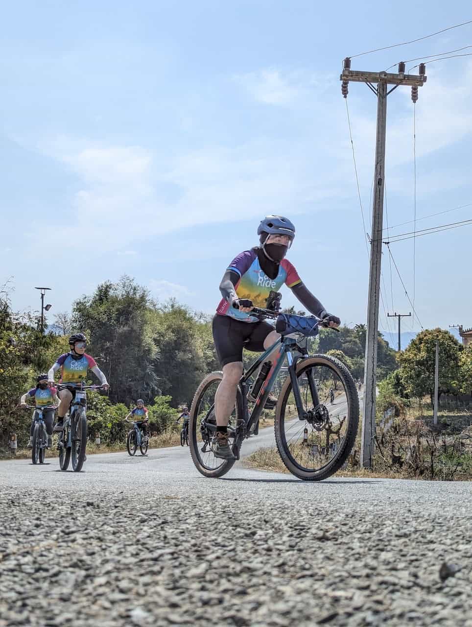 Cyclists traveling from Cambodia to Thailand on a cross-border cycling adventure, riding through rural villages, rice fields, scenic countryside roads, and authentic local communities between Angkor Wat and Bangkok.