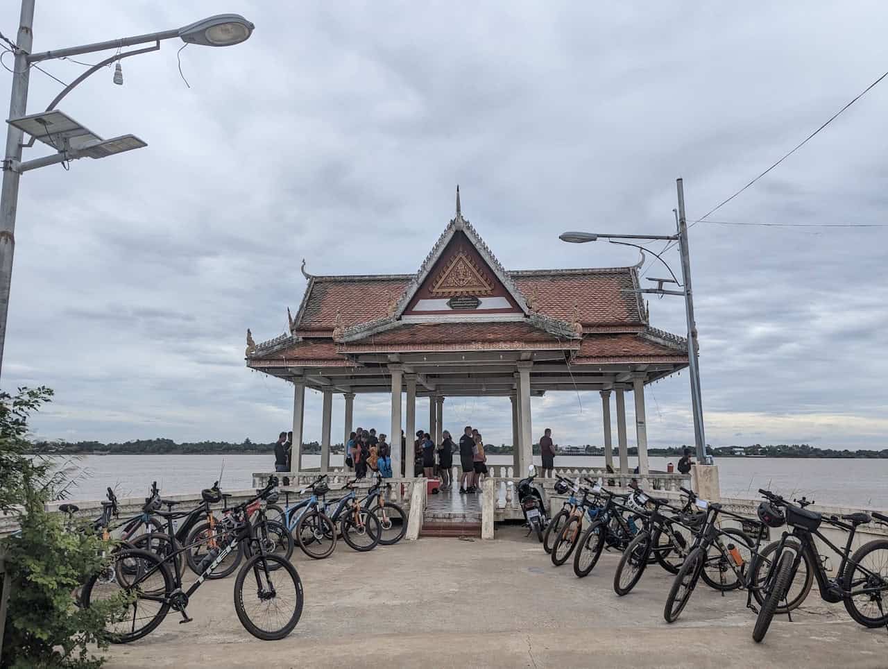 Cyclists traveling from Siem Reap to Phnom Penh on a countryside cycling tour through rural Cambodia, passing rice fields, village roads, and Mekong region landscapes.