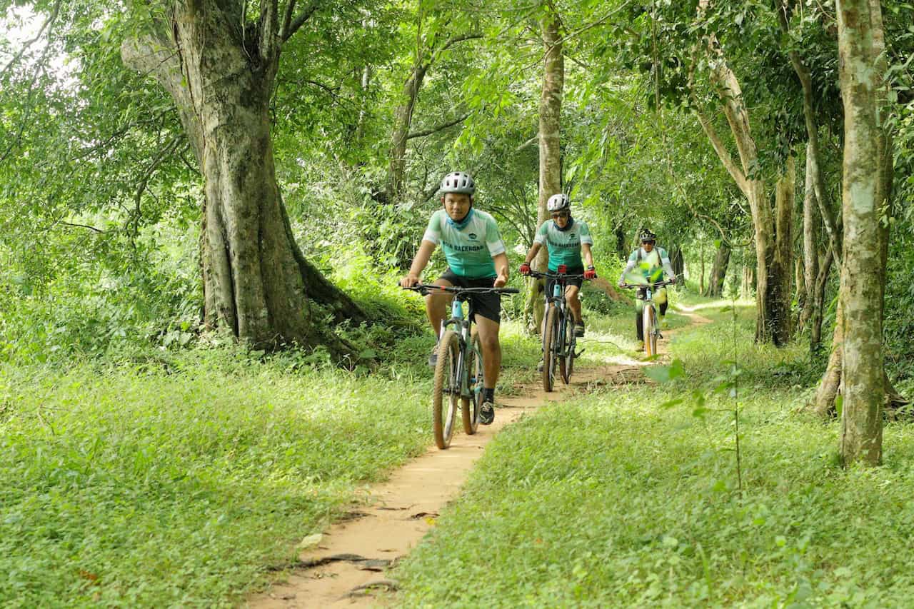 Cyclists riding from Ho Chi Minh City to Angkor Wat through Vietnam and Cambodia, exploring Mekong countryside, rural villages, and scenic backroads on a cross-border cycling expedition.