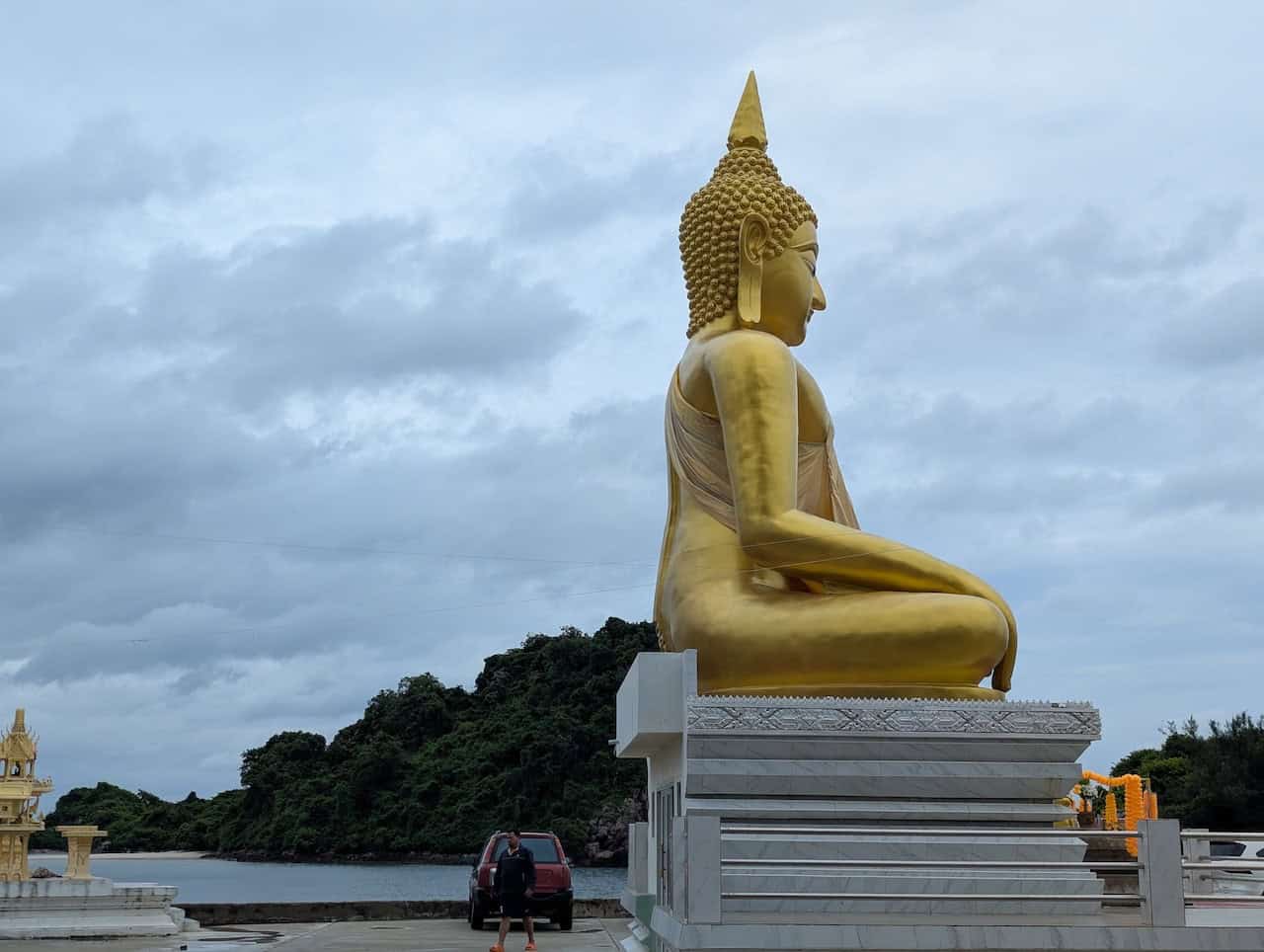Cyclists visiting a traditional Buddhist temple during a Thailand cycling holiday, exploring cultural landmarks on the journey from Phuket to Malaysia and Singapore.
