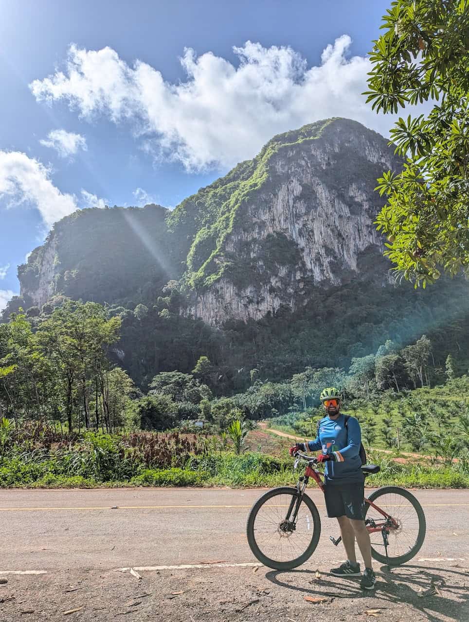 Cyclists enjoying a Southeast Asia bike touring adventure through Thailand, Malaysia, and Singapore, riding along scenic coastal roads and rural landscapes.