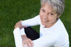 A woman happy to learn her options to determine her bone health.