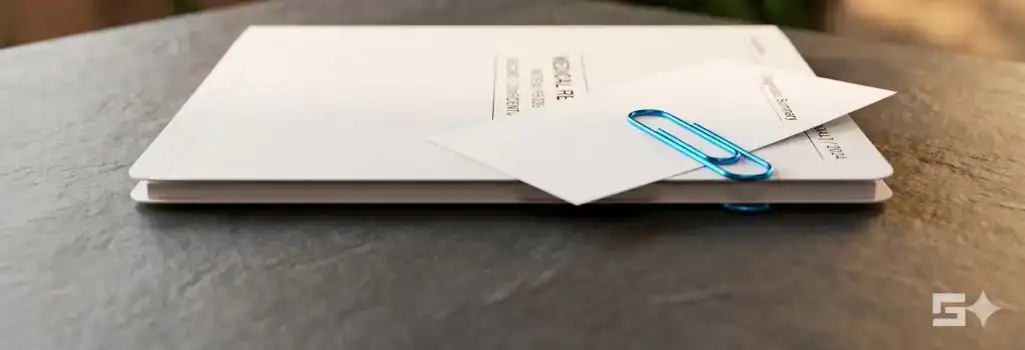 Pristine white medical records secured by an electric blue clip on a slate desk, representing the critical transition from the emergency room to a controlled personal injury claim.