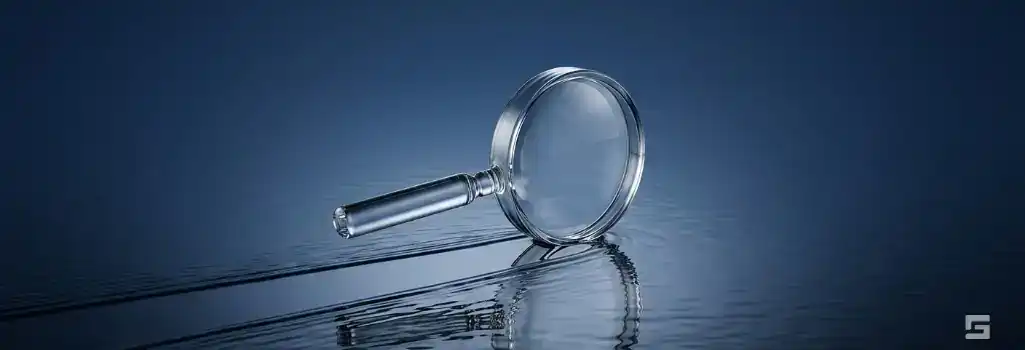 A clear glass magnifying glass clearing a path over dark water, symbolizing the expungement of a criminal record. Legal resources from Grano Law Offices, P.C.
