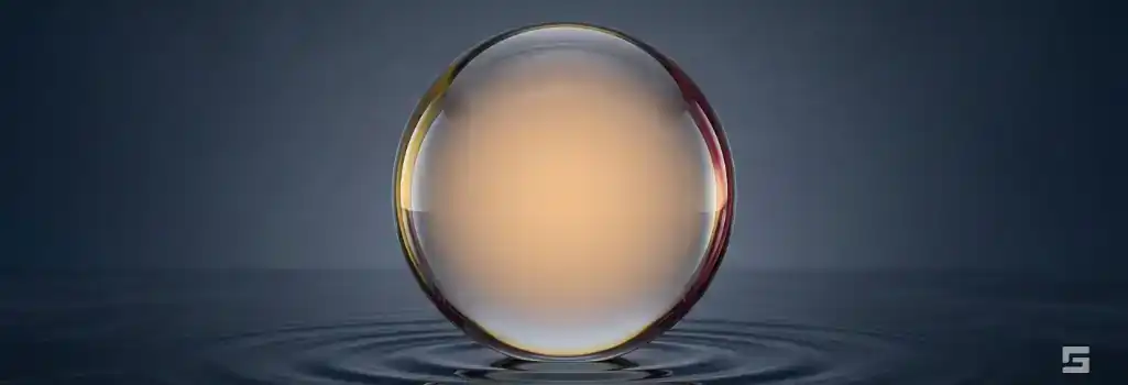 A perfectly balanced clear glass sphere with a warm amber glow on a slate gray background, representing a strong misdemeanor defense. Strategic guidance by Grano Law Offices, P.C.