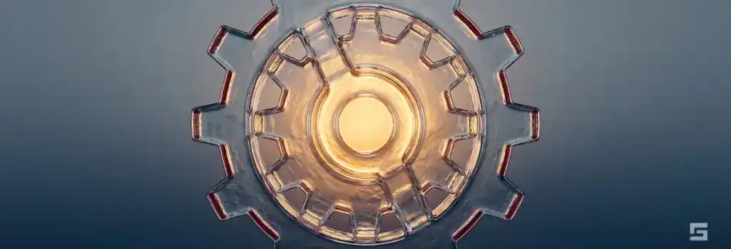 Abstract clear glass industrial gears glowing with warm amber light over a slate gray background, representing steadfast legal defense for blue-collar crimes in New Mexico. Strategic criminal defense resources by Grano Law Offices, P.C.