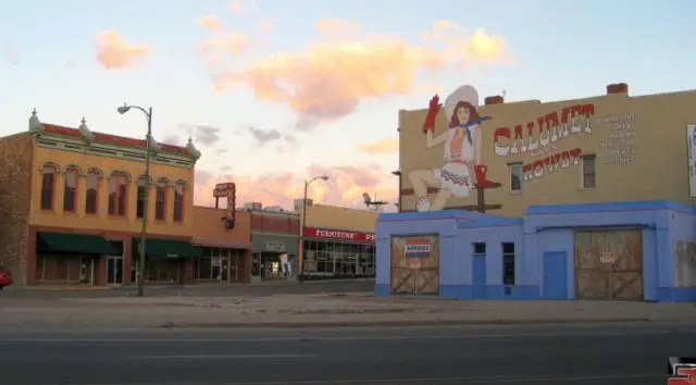 A historic building in Las Vegas, New Mexico, showcasing a vintage advertisement, highlighting the city's rich past and its connection to Route 66.