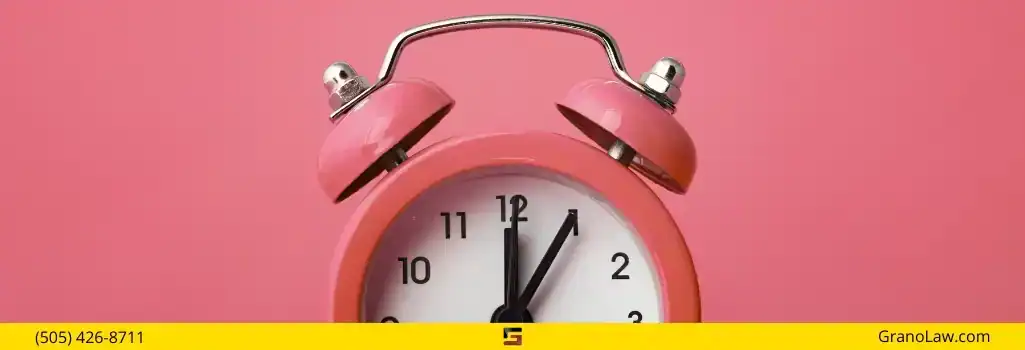 A pink alarm clock with the time approaching 1:05, symbolizing the urgent legal deadlines in a case, with Grano Law Offices, P.C.'s branding.