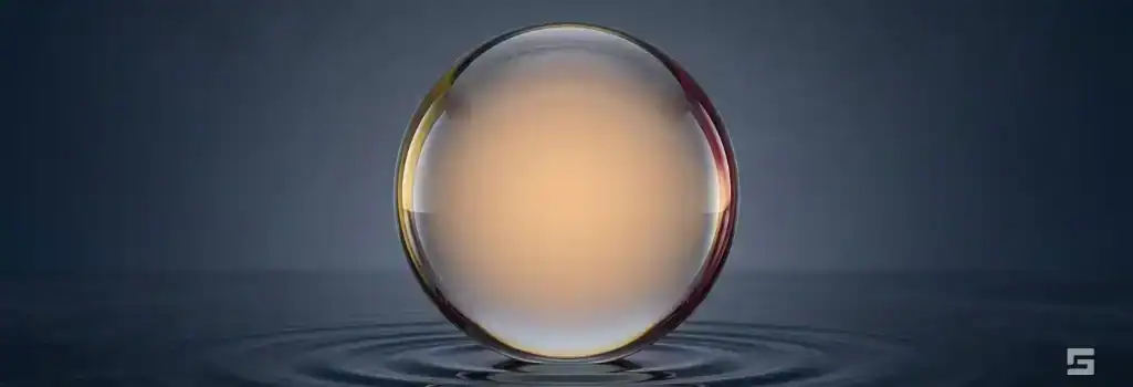 A perfectly balanced clear glass sphere with a warm amber glow on a slate gray background, representing a strong misdemeanor defense. Strategic guidance by Grano Law Offices, P.C.