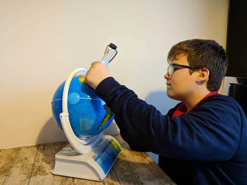 Young boy using the stylus on the Oregon Scientific Smart Globe Explorer AR