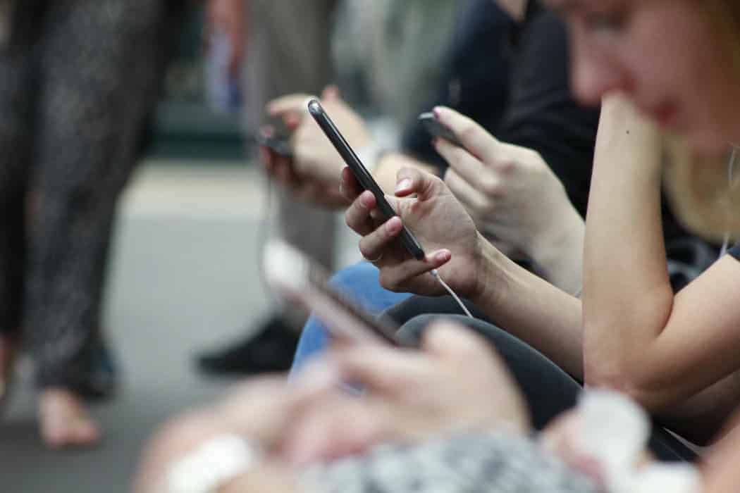 A closeup of hands holding smartphones
