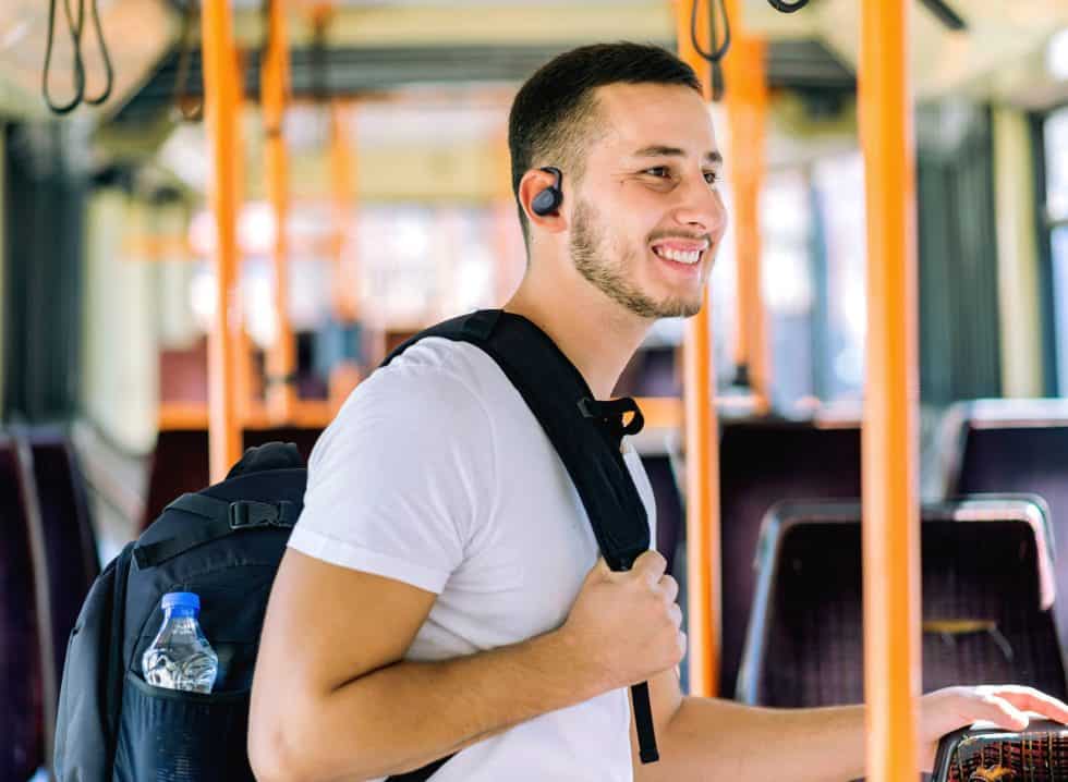 Handsome Tourist with Backpack and Toothy Smile Enjoy to Travel With Bus