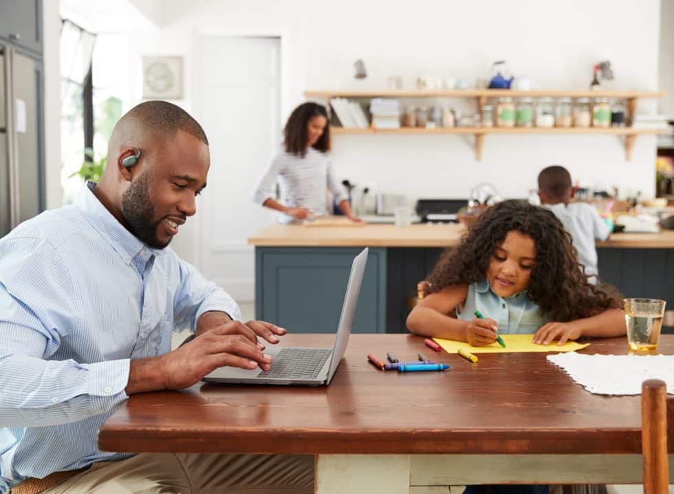 Young black family busy working in their kitchen