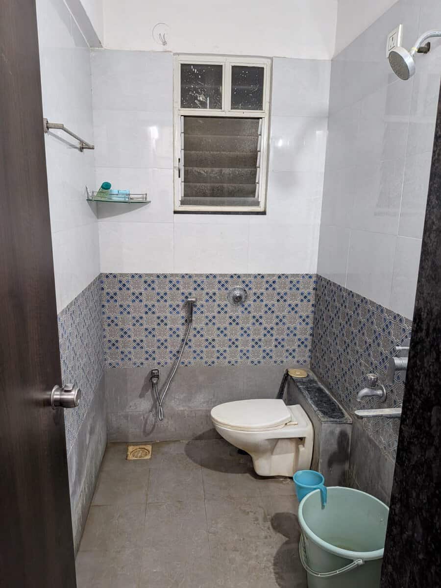 Designer tiled bathroom with shower in Estella Wakad 2 BHK flat on rent