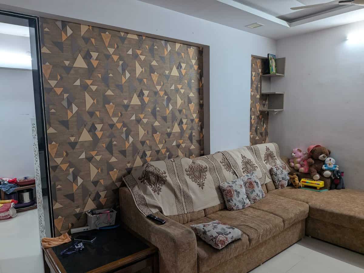 Semi furnished 2 BHK for rent in Estella Wakad Pune living room with designer accent wall and sofa