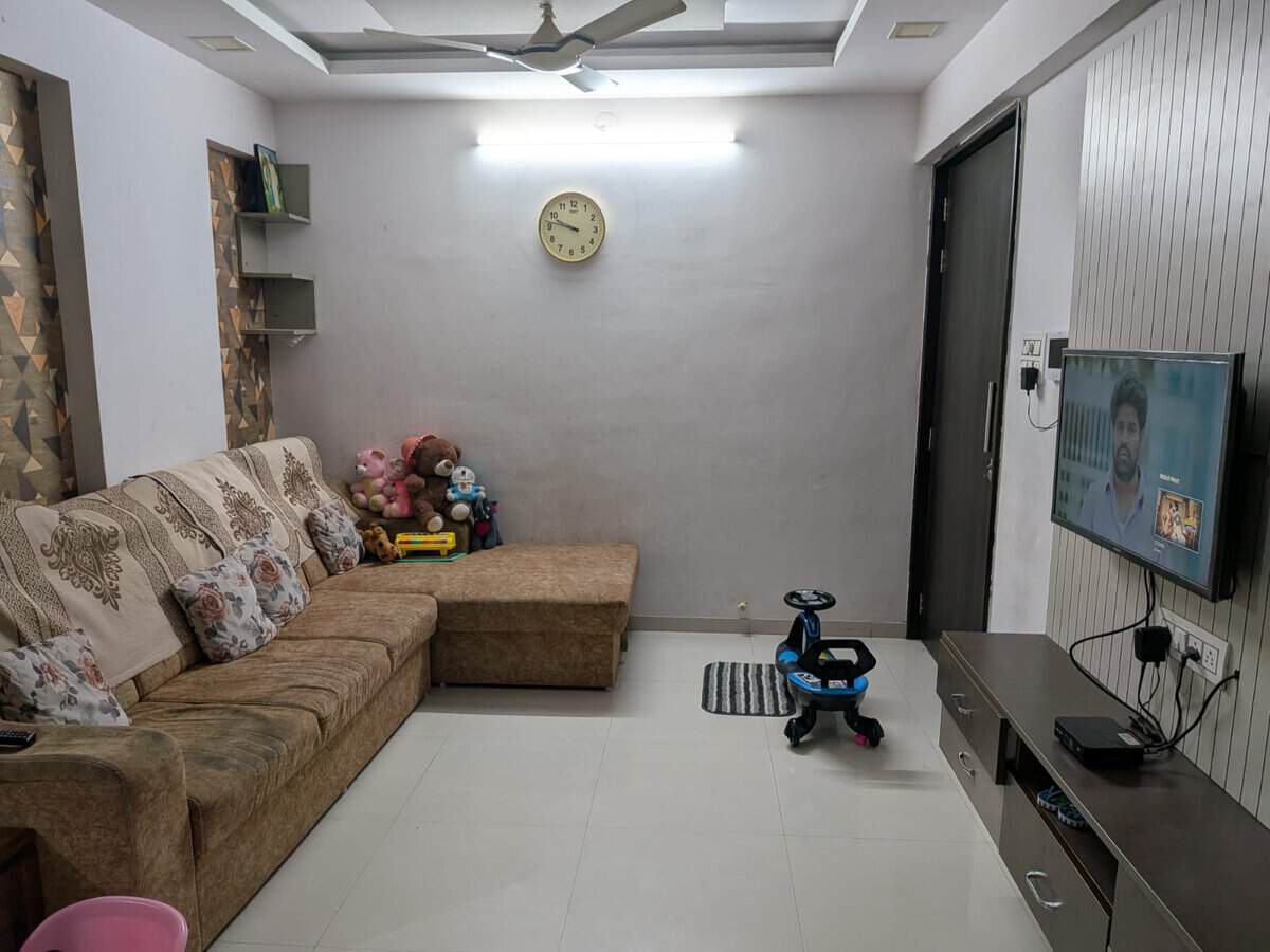 Living room TV unit and family seating area in Estella Wakad 2 BHK rental flat