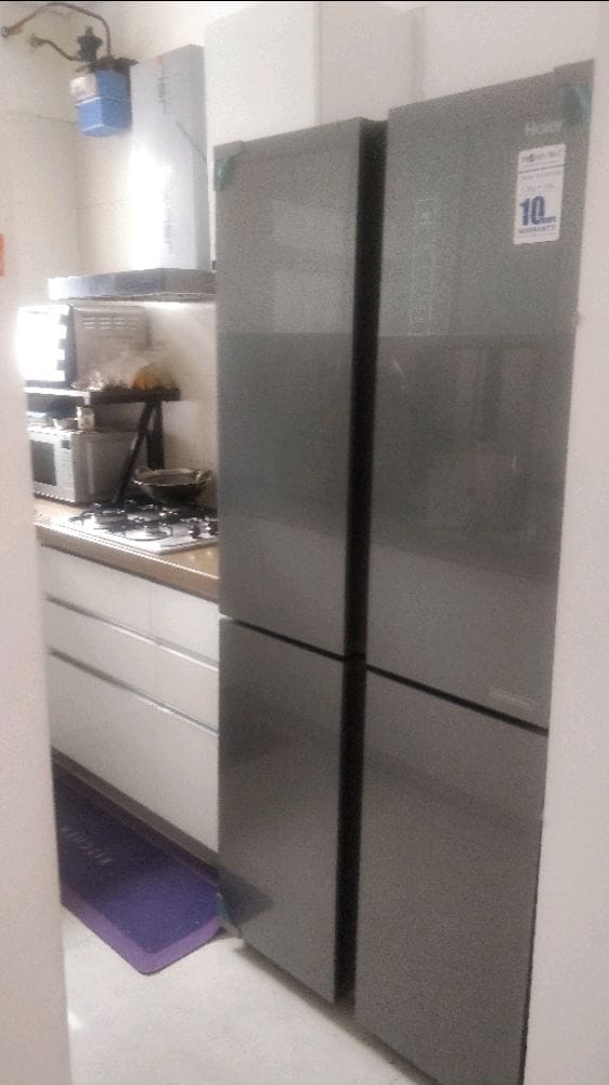 Modular kitchen with 4-door refrigerator, hob, oven and microwave in EON Homes Hinjewadi flat