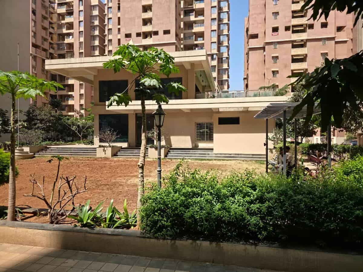 GK Aarcon Punawale society clubhouse with landscaped garden and towers