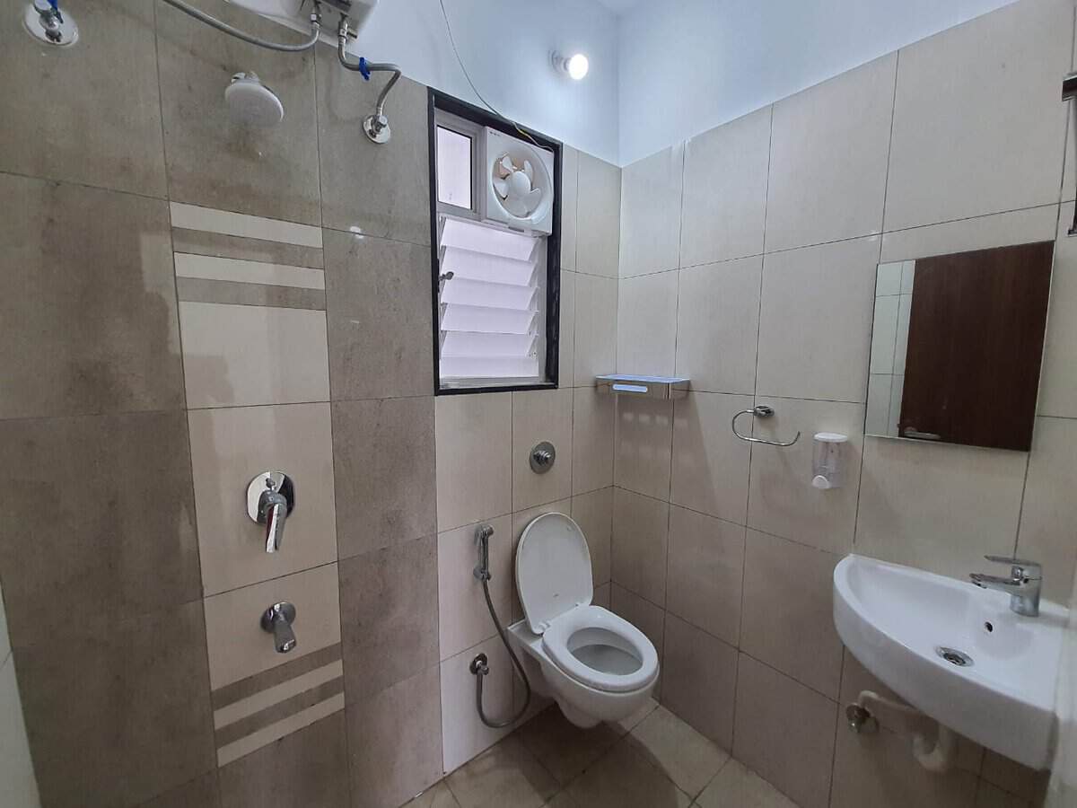 Second bathroom with shower and wall-hung toilet in 2 BHK rental flat Yashone Hinjewadi Pune